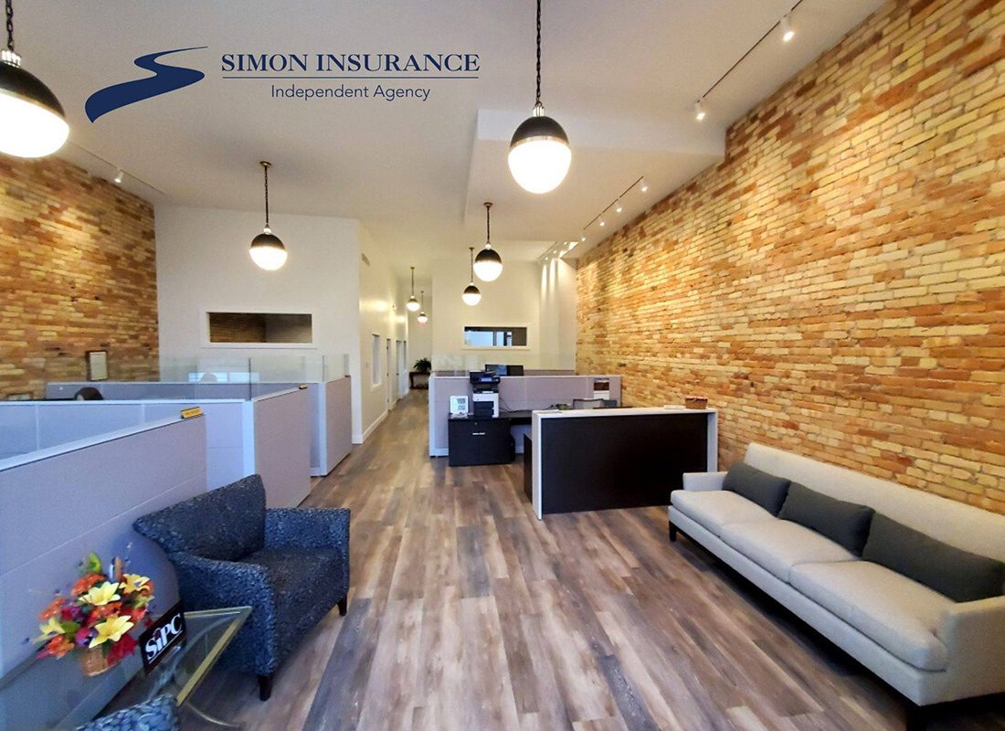 Contact - View Inside Modern Simon Insurance Agency Office in Portland Michigan with Brick Walls and Wood Floors