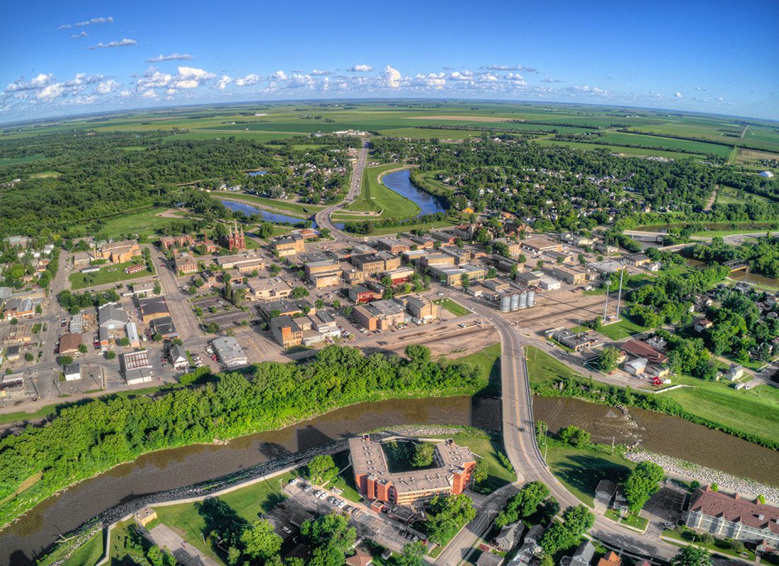 Portland, MI - Aerial View of the Town of Portland Michigan with Homes and Buildings by the Lake Surrounded by Green Foliage on a Sunny Day